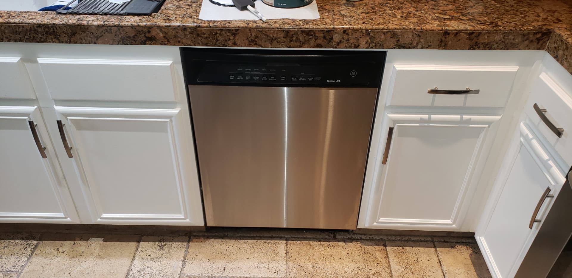Same sink and dishwasher cabinet run refinished in clean white with new hardware